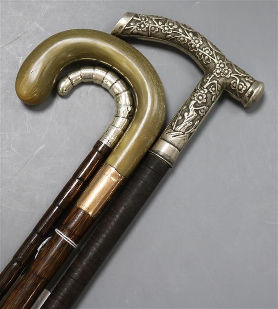 Two silver mounted and handled walking sticks and a horn, 9ct mounted walking stick